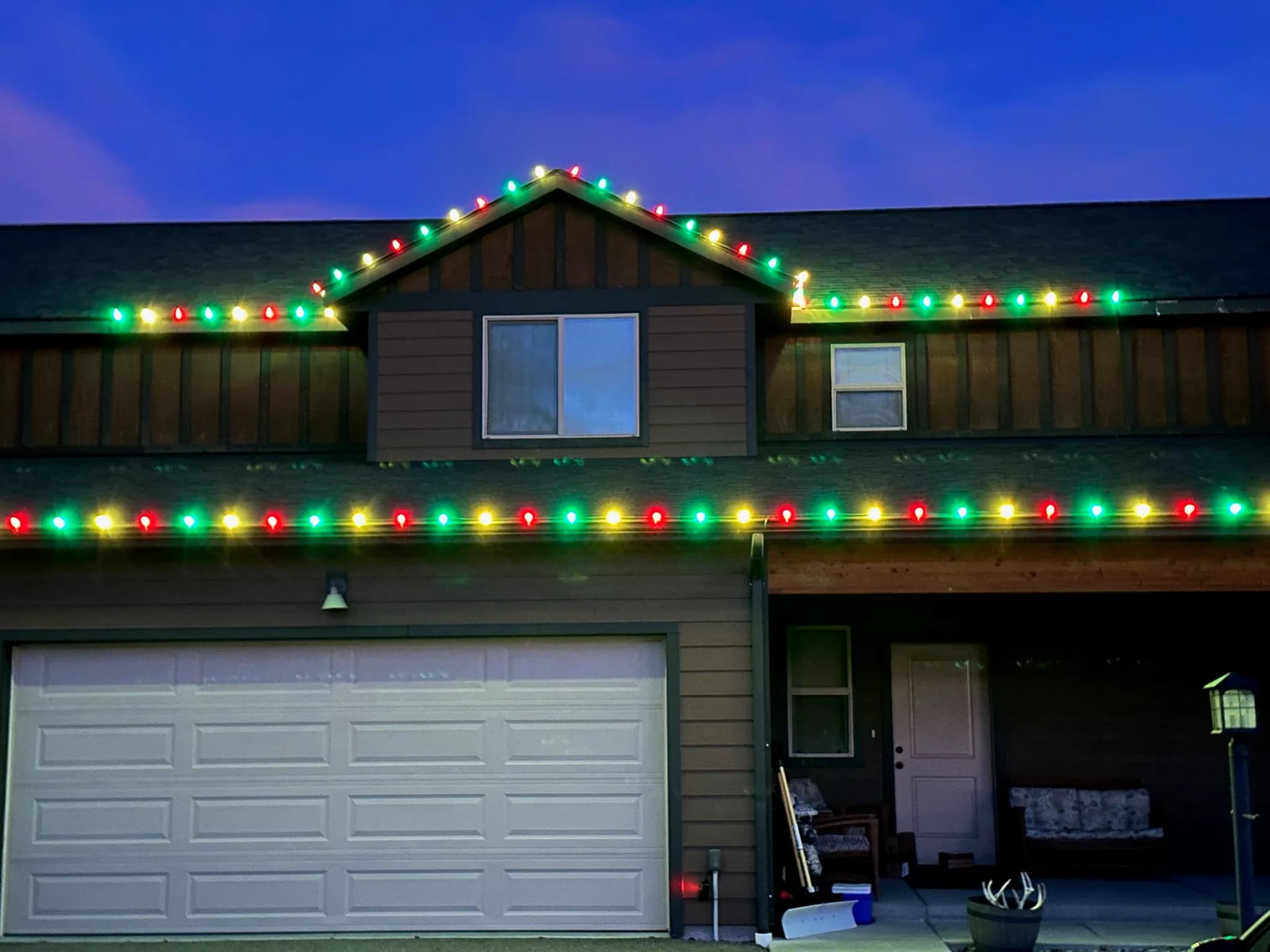 Two-story home with multicolor C9 bulbs running along every roofline